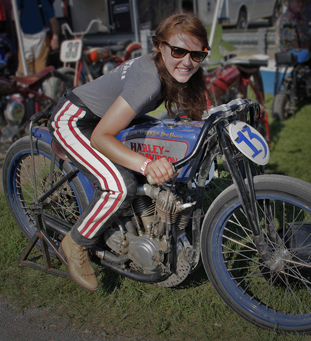 Person on vintage motorcycle, smiling enthusiastically