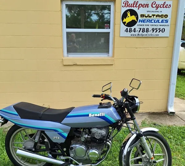 Vintage motorcycle in front of repair shop